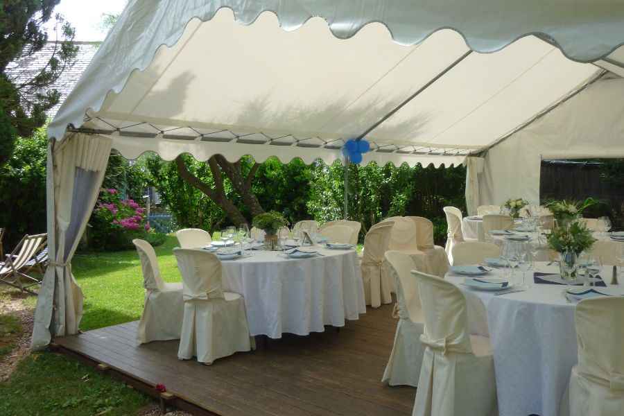 Tables et chaises décorées sous une tente